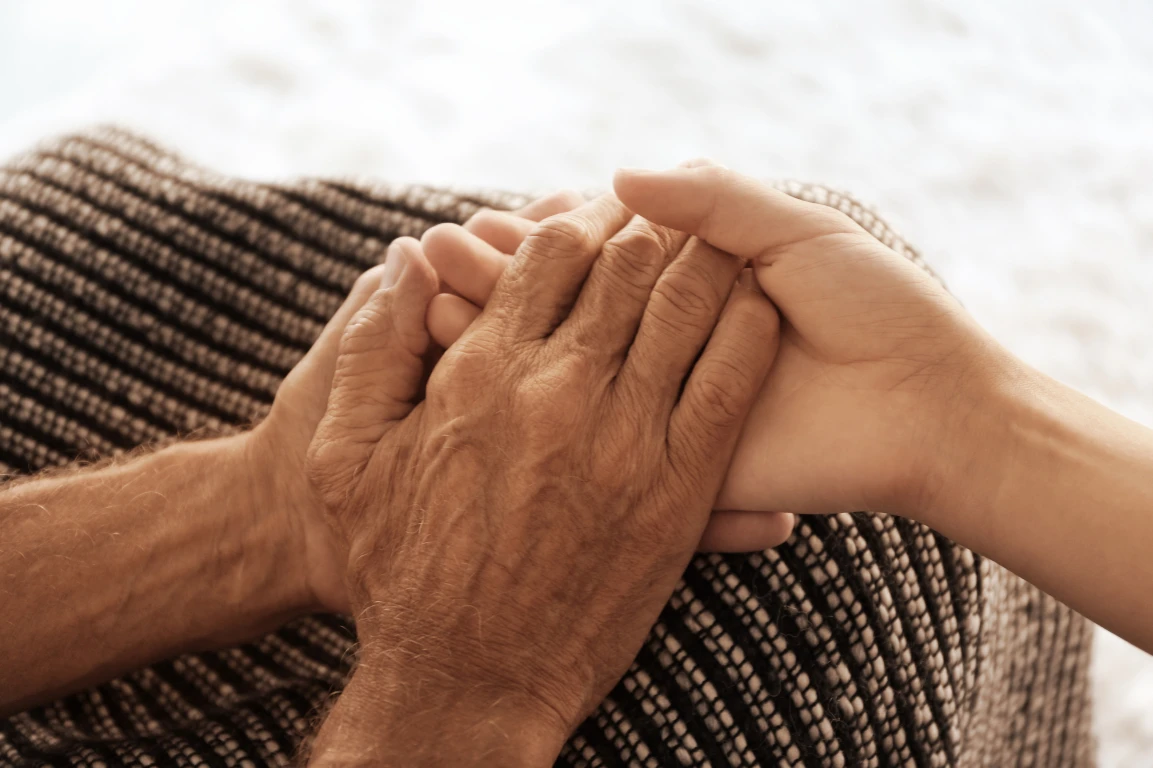 Hands being held to show trust for mandy's companion care.